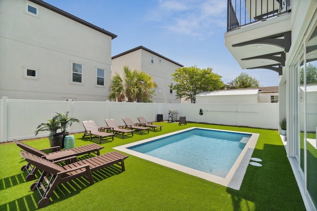 view of swimming pool with a yard and a patio area