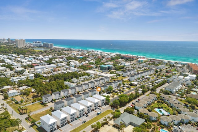 drone / aerial view featuring a water view and a view of the beach