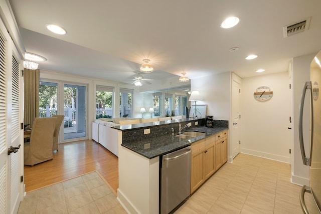 kitchen with light hardwood / wood-style floors, ceiling fan, dark stone countertops, sink, and dishwasher