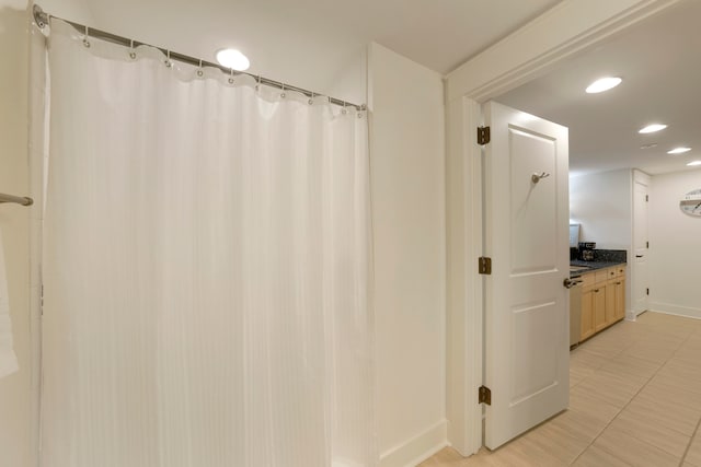 bathroom featuring vanity and curtained shower