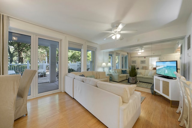 living room featuring ceiling fan and light hardwood / wood-style floors