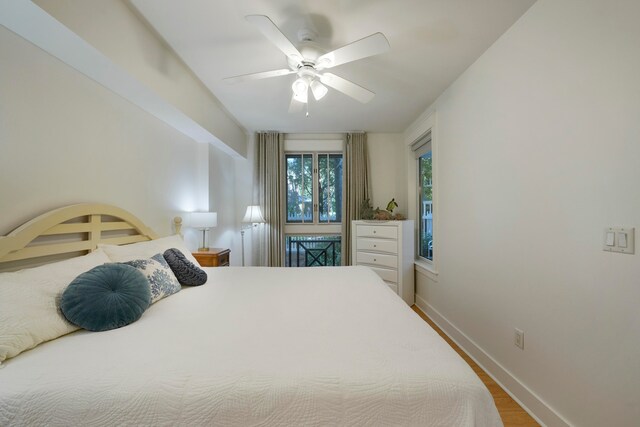 bedroom with ceiling fan and hardwood / wood-style floors