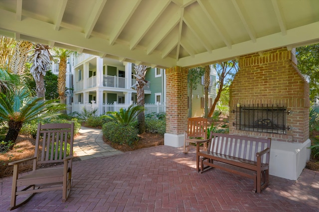 view of patio with an outdoor brick fireplace