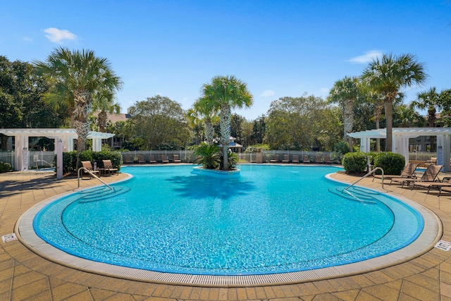 view of swimming pool with a patio and a pergola