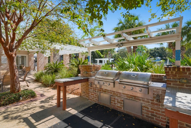 view of patio / terrace with a grill, an outdoor kitchen, and a pergola