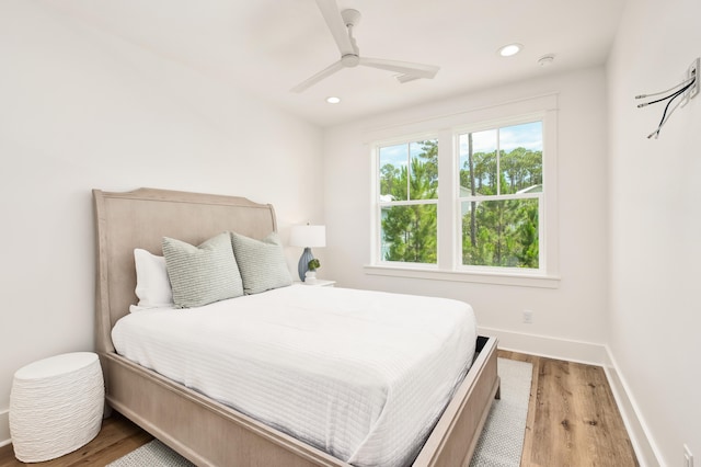 bedroom with wood-type flooring and ceiling fan