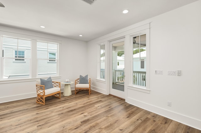 living area with light wood-type flooring and a wealth of natural light