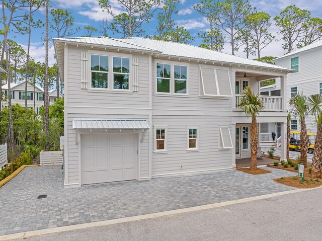 view of front facade with a balcony and a garage