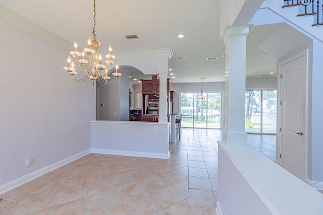 kitchen with hanging light fixtures, light tile patterned flooring, a chandelier, and ornamental molding