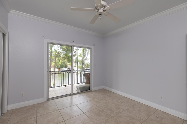 spare room with ceiling fan, ornamental molding, and light tile patterned floors