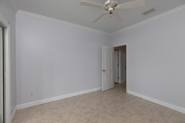 tiled empty room featuring ceiling fan and ornamental molding