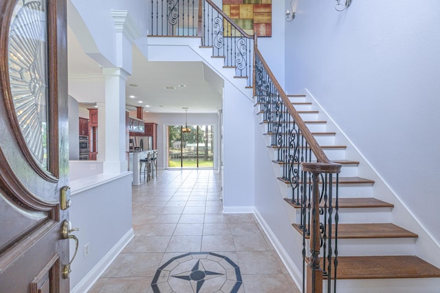 tiled entrance foyer with decorative columns