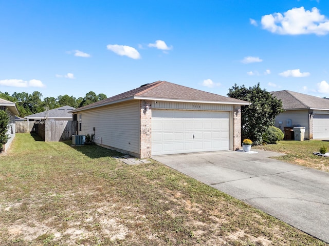 exterior space featuring central AC unit, a garage, and a lawn