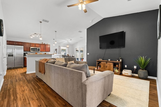 living room featuring dark wood-type flooring, lofted ceiling, and ceiling fan