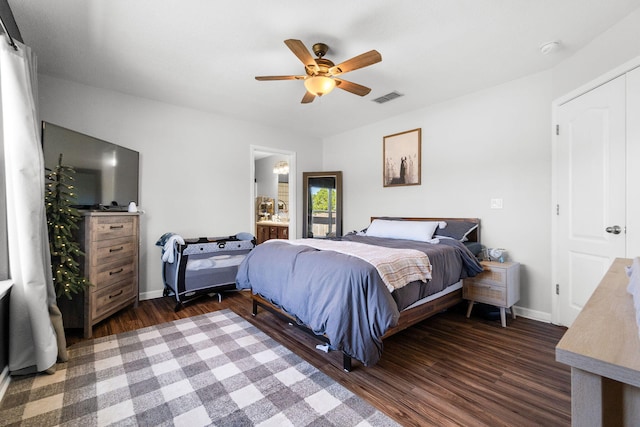 bedroom with dark hardwood / wood-style floors, ensuite bath, and ceiling fan