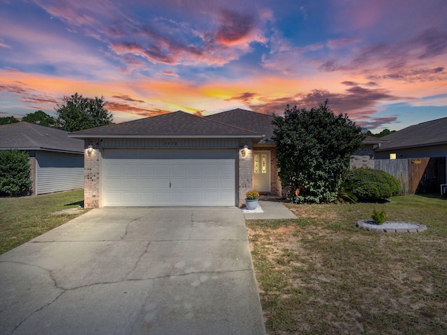 view of front of home featuring a garage and a lawn