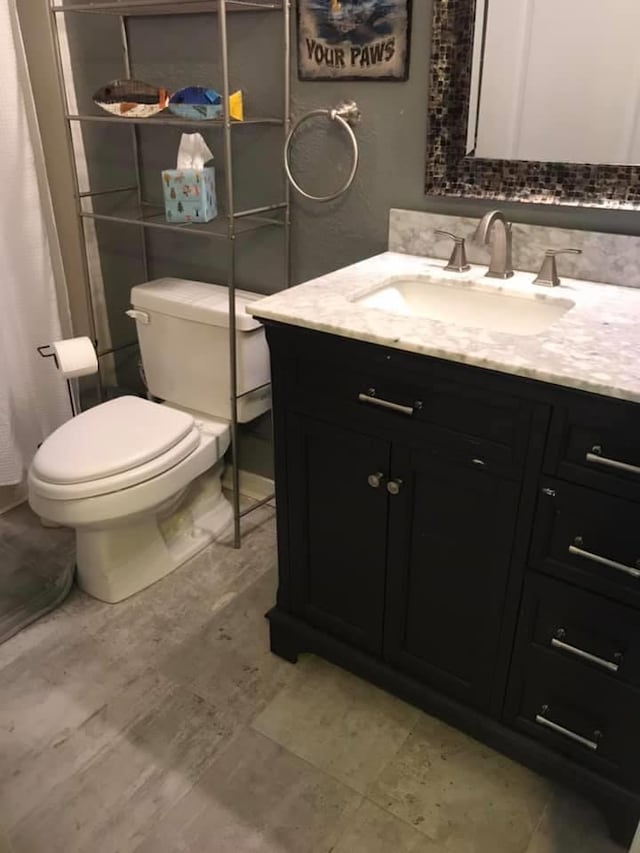 bathroom featuring toilet and vanity