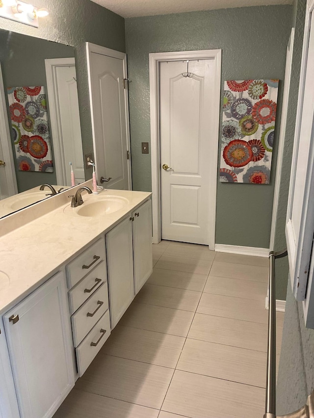 bathroom with tile patterned floors and vanity