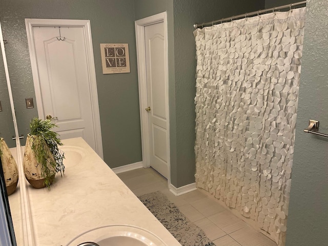 bathroom featuring vanity, tile patterned flooring, and a shower with shower curtain