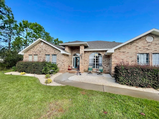 view of front facade with a front lawn and a patio area