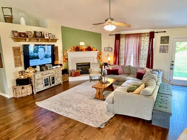 living room featuring ceiling fan and dark hardwood / wood-style flooring