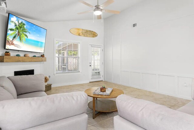 living room featuring ceiling fan and high vaulted ceiling