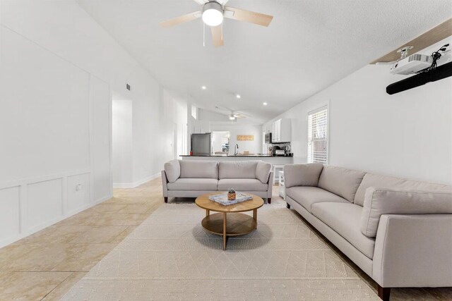 living room with lofted ceiling and ceiling fan