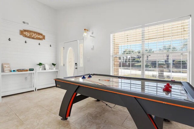 recreation room with a healthy amount of sunlight and light tile patterned floors