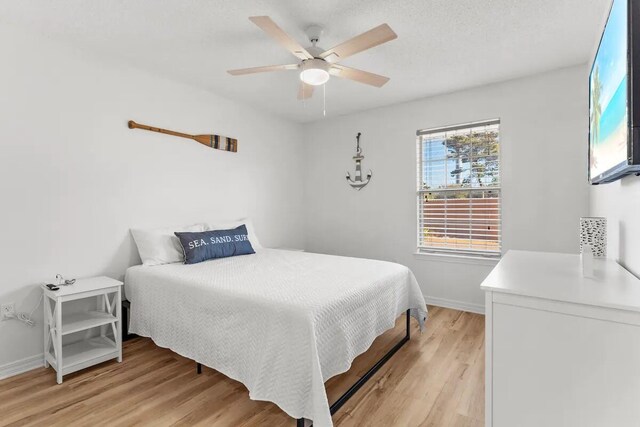 bedroom featuring ceiling fan and light hardwood / wood-style flooring