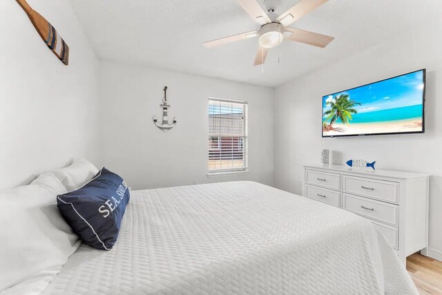 bedroom with ceiling fan and light hardwood / wood-style floors