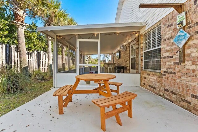 view of patio with a sunroom