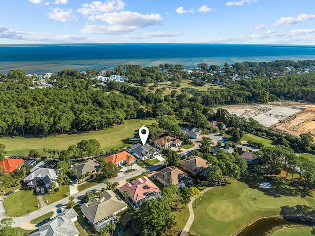 drone / aerial view with a water view, view of golf course, and a residential view