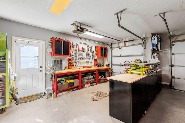 garage with a garage door opener and a workshop area