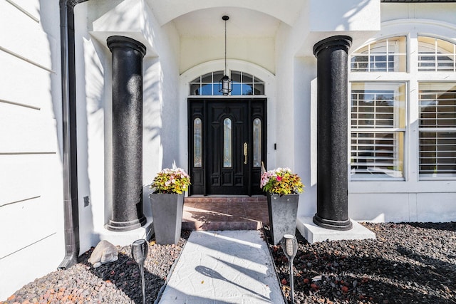 entrance to property featuring stucco siding