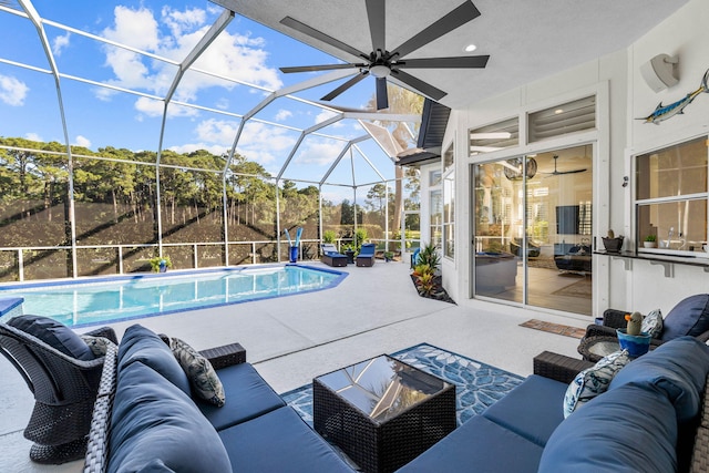 outdoor pool with glass enclosure, a patio, outdoor lounge area, and a ceiling fan