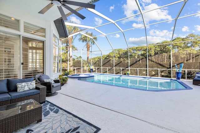 view of pool featuring an outdoor living space, a ceiling fan, a patio area, a lanai, and a pool with connected hot tub
