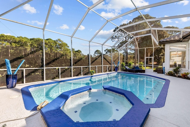 view of pool featuring an in ground hot tub, a lanai, and a patio area