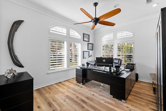 office area featuring crown molding, a ceiling fan, baseboards, and light wood-style floors