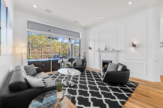 living room featuring wood-type flooring and ornamental molding