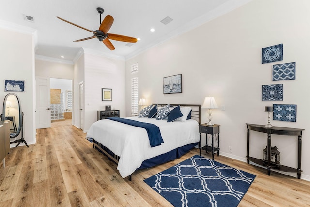 bedroom with ceiling fan, ensuite bath, hardwood / wood-style floors, and crown molding