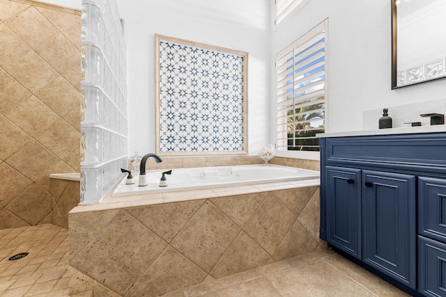 full bath featuring a tile shower, a bath, and vanity
