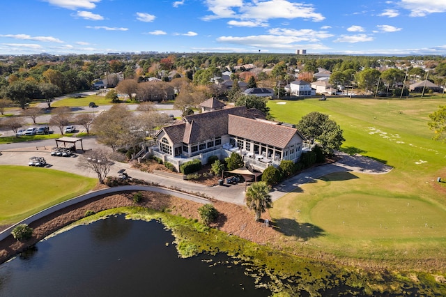 drone / aerial view with view of golf course and a water view