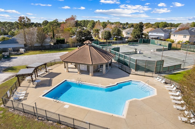 community pool featuring a patio, a gazebo, and fence