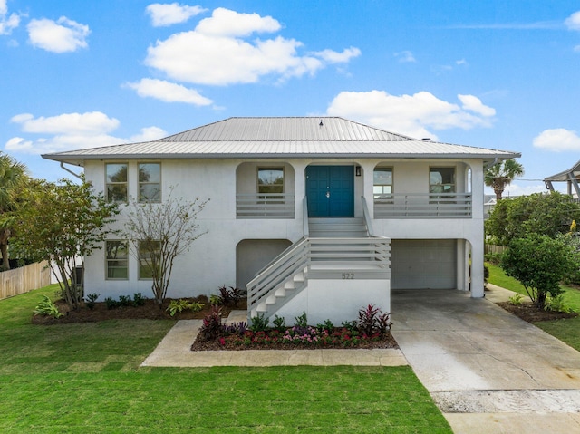 view of front of home with a garage and a front lawn