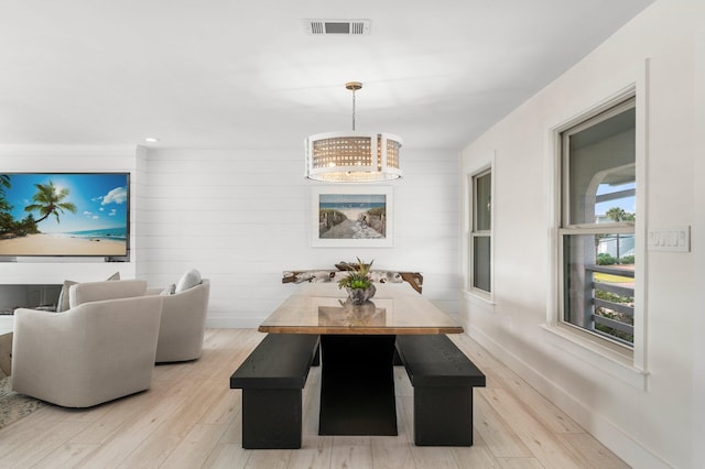 dining room with a chandelier and light hardwood / wood-style flooring