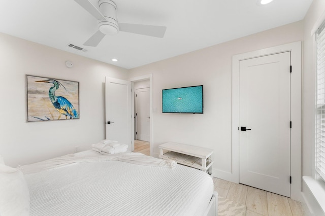 bedroom with ceiling fan and light hardwood / wood-style floors