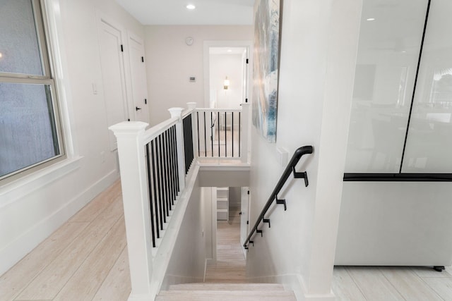 stairs featuring hardwood / wood-style floors