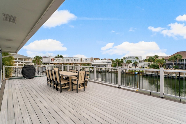 wooden deck featuring a water view