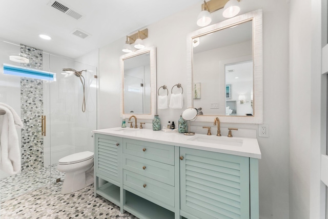 bathroom featuring an enclosed shower, vanity, and toilet