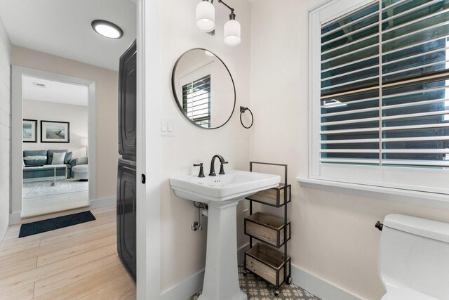 bathroom featuring toilet and wood-type flooring